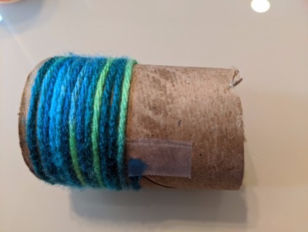 Recycled Paper Tube Bug Toy - wrapping tube with yarn