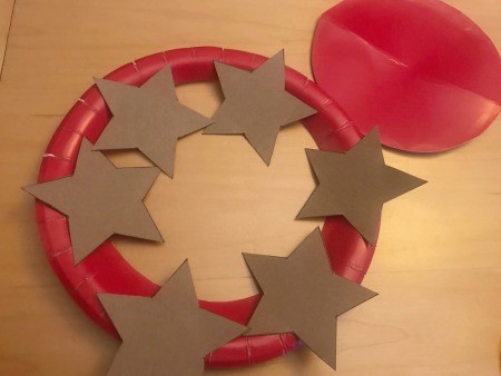 Recycled Paper Memorial Day Wreath - center cut out of plate and stars arranged before painting and glueing