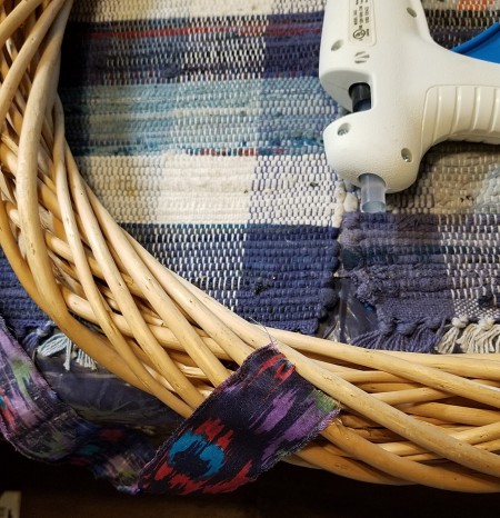 Spring Calving Season Cowboy/Cowgirl Wreath - glue gun and wreath with the multicolored western shirt fabric strip ready to wrap