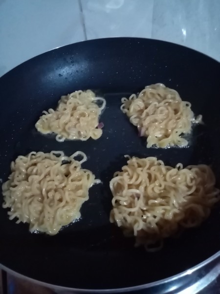flattened noodle bunches in pan
