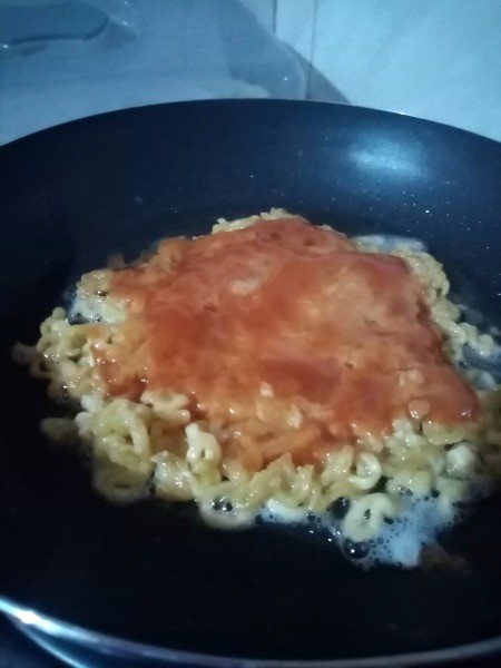 cooked noodles with sauce on top
