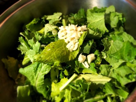 adding greens to pan