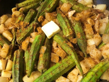 adding spices & butter to Okra & Potatoes