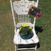 Garden Flowerpot Chair Planter - finished planter with yellow flowers and the bee garden sign