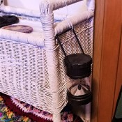 A Dollar Store lantern hung near a bed.