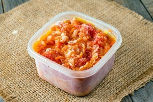 A container of frozen tomato sauce.