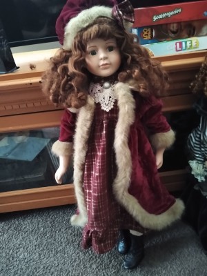 Value of a Collectors Choice Porcelain Doll - doll wearing a long plaid dress with a white fur trimmed coat and matching hat