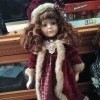 Value of a Collectors Choice Porcelain Doll - doll wearing a long plaid dress with a white fur trimmed coat and matching hat