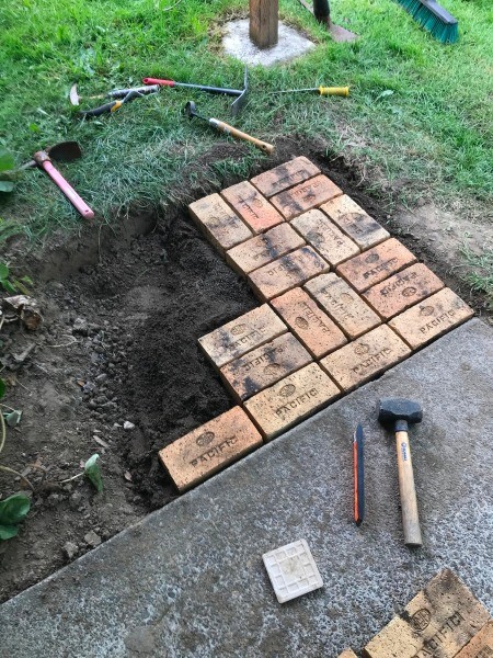 Adding bricks to the patio.