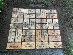 A patio made from orange yellow bricks.