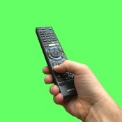 A remote control on a green background.