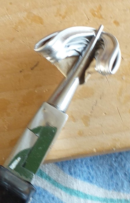 Orchid Made from Empty Nespresso Coffee Cups - pliers holding a folded cup