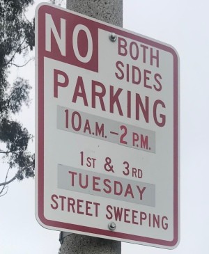 A parking sign that states "No Parking Both Sides"