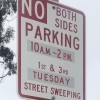 A parking sign that states "No Parking Both Sides"
