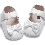 A white pair of baby shoes.