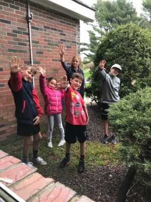 A family waving at their grandma.