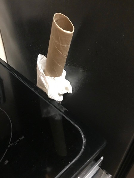 A paper towel tube with a paper towel at the end.