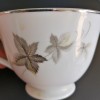 Value of Noritake China - white tea cup with silver edge and gray leaves