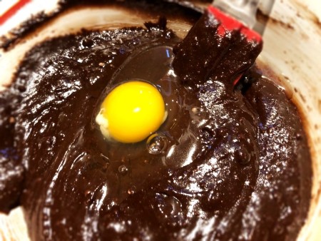 adding egg to Brownie batter