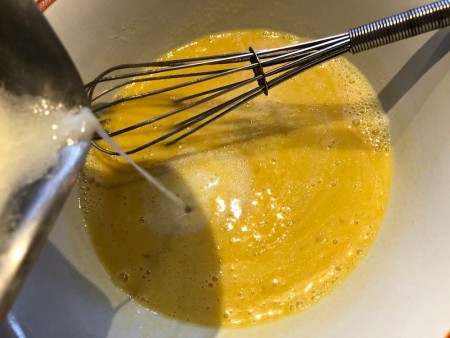 adding milk & butter to eggs