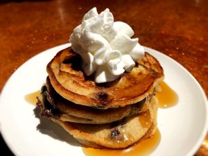 stack of Chocolate Chunk Pancakes with whipped cream