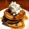 stack of Chocolate Chunk Pancakes with whipped cream