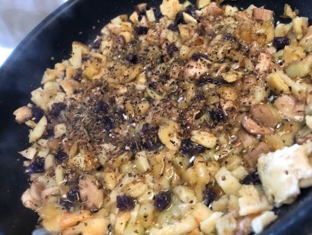 adding spices to stuffing