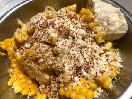 mixing corn, cheese, mayo & spices