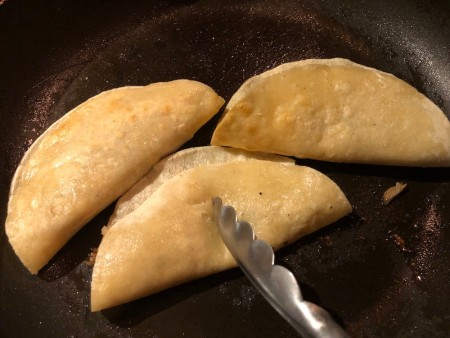 filled tortillas in pan