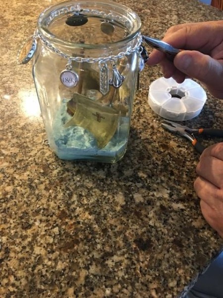 Message on a Bottle (Emigrant Ancestors) - charms etc. on a bit of chain around the top of the jar