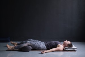 A woman relaxing with head and legs raised.