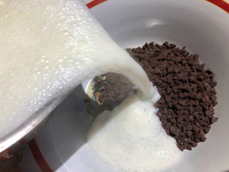 pouring melted marshmallows over chocolate chips