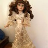 Value of a Collector's Choice Series Doll by DanDee - doll with long dark curls wearing an embroidered ecru dress