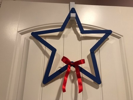 Minimal Star Craft Stick Wreath - star hanging on an over the door hook