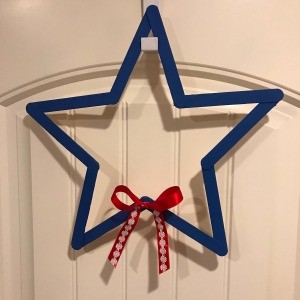 Minimal Star Craft Stick Wreath - closeup of star wreath with the red and white bow