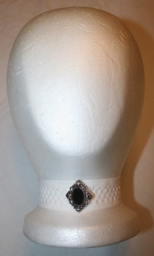 Four Necklaces for a Dollar - foam head with a white headwrap necklace with a vintage style button in the center