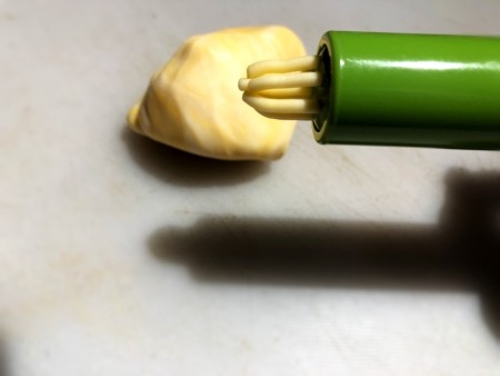 Gravity-Defying Ramen Cake - push small batches of yellow fondant through fondant extruder