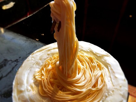 Gravity-Defying Ramen Cake - continue wrapping until fondant covering the straws is completely covered, add more noodles to top of cake