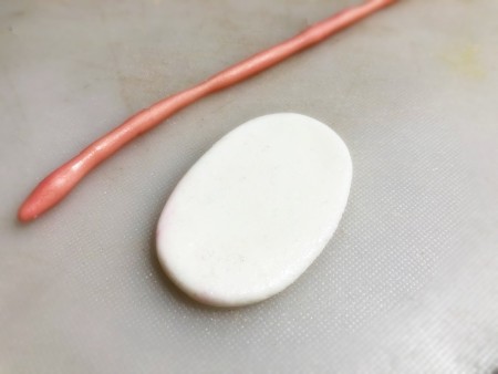 Gravity-Defying Ramen Cake - white fondant oval and thin string of pink for making fish cake