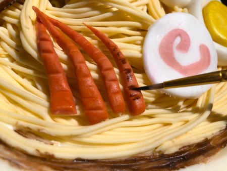 Gravity-Defying Ramen Cake - touch a bit of the brown food coloring to the scored lines on the carrots