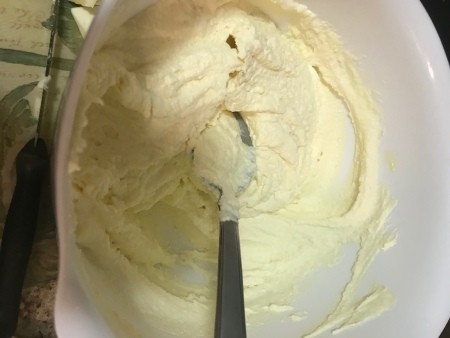 mixing ricotta and eggs in bowl