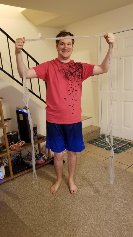 DIY Crochet Plarn Sleeping Mats - young man holding length of plarn