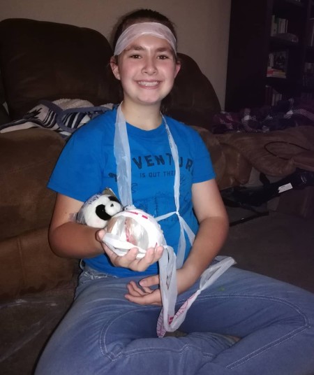 DIY Crochet Plarn Sleeping Mats - young girl holding a ball of plarn