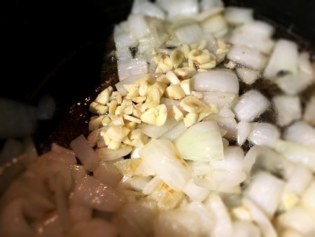 adding garlic to onion