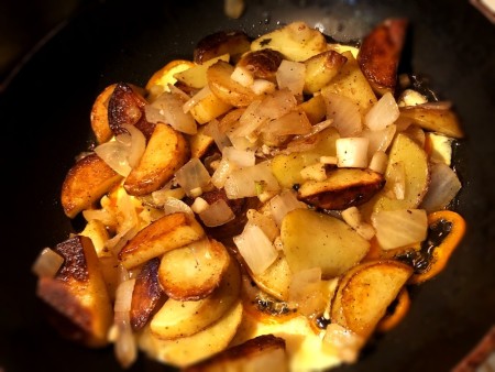 Potatoes on egg & peppers