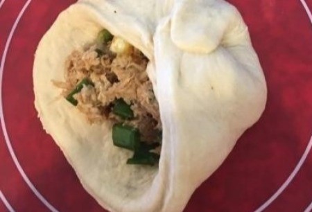 pinching dough together around filling