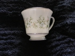Value of Noritake China - white cup with silver edge and a pastel floral pattern