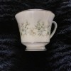 Value of Noritake China - white cup with silver edge and a pastel floral pattern