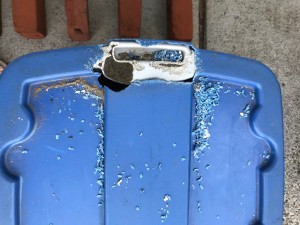 A plastic tub with a large hole chewed on the top.