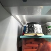 Upside down container of yogurt in the fridge